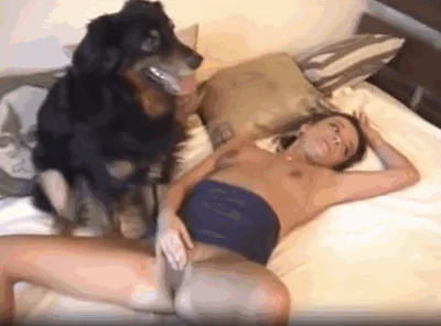 Blonde gets fucked by black dog on big bed