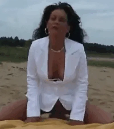 Sitting on the beach licking her bloody pussy