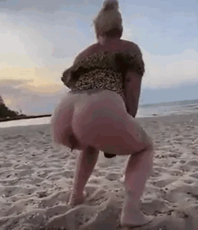 Pretty blonde poops on the beach